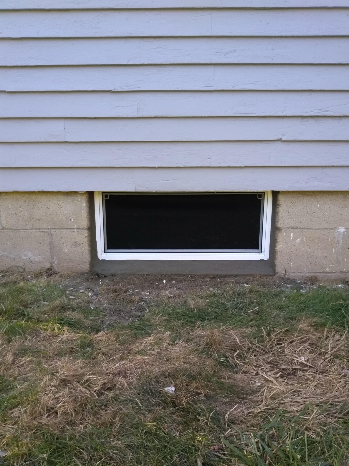 White replacement basement window after installation